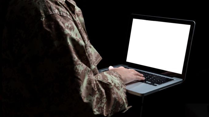 Picture of Military Veteran in Uniform Using Computer Laptop